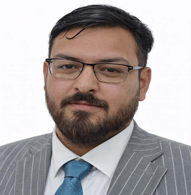 Professional headshot of a man with dark hair and glasses wearing a gray pinstripe suit and blue tie.