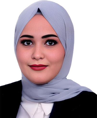 Portrait of a woman wearing a light gray hijab and professional attire, looking at the camera.